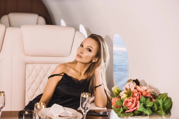 그녀의 전화와 비즈니스 클래스 비행기의 오두막에서 아름다운 편안한 럭셔리 — 스톡 사진