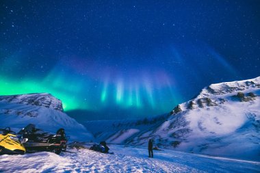 The polar arctic Northern lights hunting aurora borealis sky star in Norway travel photographer  Svalbard in Longyearbyen city the moon mountains clipart
