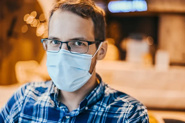 Airport european nerd man in glasses and plaid shirt with luggage tourist boarding plane taking a flight  wearing face mask. Coronavirus flu virus travel