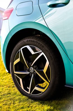 Tnsberg, Norveç - SEPT 17, 2020: gök mavisi VOLKSWAGEN VW I.D.3, MEB platformuna dayalı kompakt C segment elektrikli otomobil. Güneşli bir günde yeni bir araba. Covid19 sırasında maske takan inek bir adam.. 