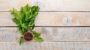 Biber ve kereviz yaprakları. Ahşap bir arka plan üzerinde. Üstten Görünüm. Kopya alanı.