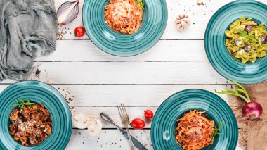 Tabak pişmiş macunlar kümesi. Ahşap bir arka plan üzerinde. İtalyan mutfağı. Üstten Görünüm. Kopya alanı.