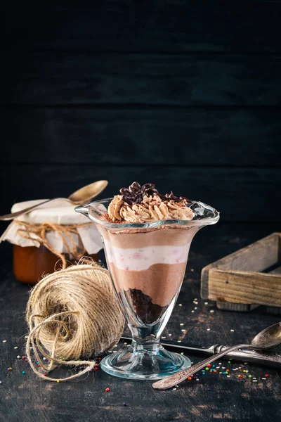 Chocolate blackberry dessert with mint. On a wooden background. Top view. Copy space.