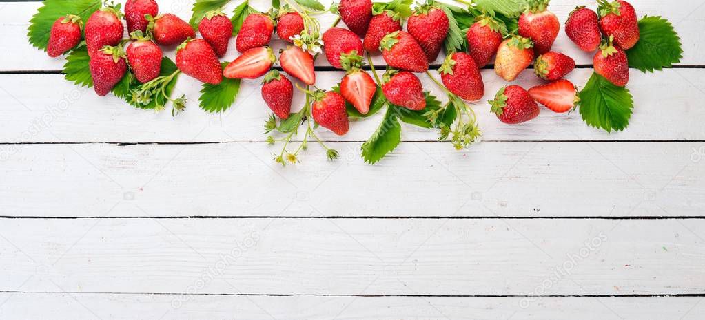 Fresh strawberries. On a white wooden background. Top view. Copy space.
