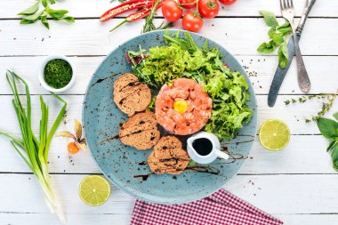 Tartar somon ve avokado. Ahşap bir arka plan üzerinde. Üstten görünüm. Kopya alanı