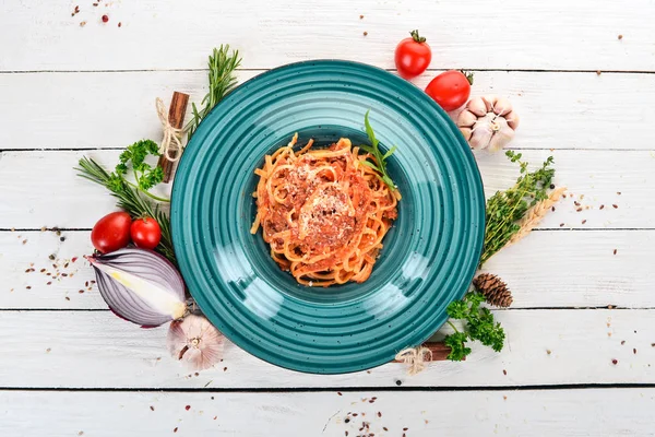 Domatesli makarna makarna. Ahşap bir arka plan üzerinde. İtalyan mutfağı. Üstten Görünüm. Kopya alanı.