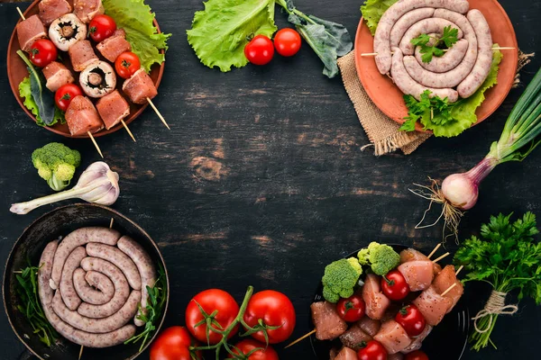 Assortment Meat Barbecue Sausages Skewers Vegetables Wooden Background Top View — Stock Photo, Image