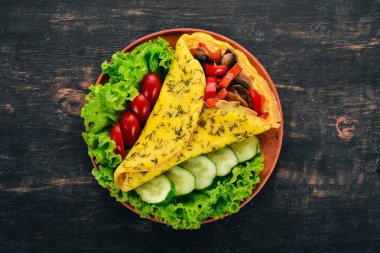 Omlet mantar ve sebze. Kızarmış yumurta. Ahşap bir arka plan üzerinde. Üstten görünüm. Ücretsiz kopya alanı.