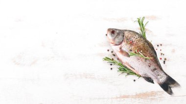 Baharatlar ve sebzeler çiğ balık. Sazan ahşap arka plan üzerinde. Üstten görünüm. Kopya alanı.