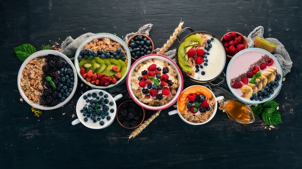 Oatmeal Yogurt Fruits Berries Plates Breakfast Black Wooden Background Top — Stock Photo, Image