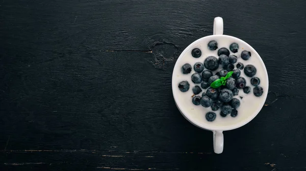 Yabanmersinli yoğurtlu. Kahvaltı. Ahşap bir arka plan üzerinde. Üstten görünüm. Metin için boş alan.
