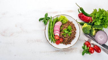 Mercimek turp, domates, fasulye ve sebze ile. Sağlıklı gıda. Beyaz ahşap bir masa üzerinde. Üstten görünüm. Metin için boş alan.