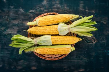 Siyah ahşap bir masa üzerinde taze sarı Mısır. Sebze. Üstten görünüm. Kopya alanı.