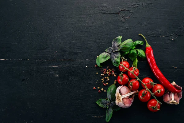 Food Background. Cherry tomatoes, spices and sauces. Top view. On a wooden background. Free space for text.