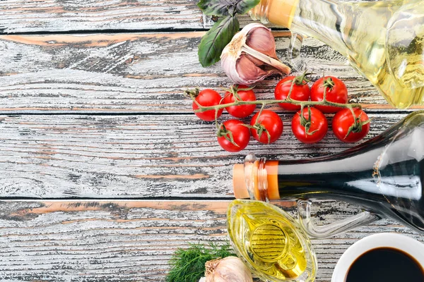 Olive oil and soy sauce in glass jars. Spices and Sauce. Top view. On a white wooden background. Free space for text.