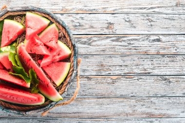 Karpuz mezarda. Karpuz parçalara dilimlenmiş. Ahşap bir arka plan üzerinde. Metin için özgür yer. Üstten görünüm.