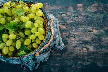 Üzüm mezarda. Üzüm yaprakları. Üstten görünüm. Siyah bir arka plan üzerinde. Metin için boş alan.