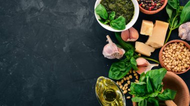 Geleneksel fesleğen pesto sos. Fesleğen, parmesan peyniri, zeytin yağı, çam fıstığı, biber, sarımsak. Üstten görünüm. Taş masanın üstünde. Metin için boş alan.