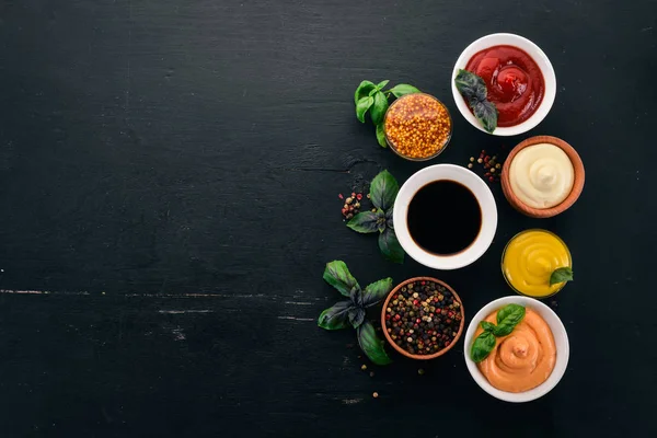 Set Sauces Black Wooden Background Ketchup Mayonnaise Mustard Soy Sauce — Stock Photo, Image
