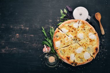 Pizza Quattro Formaggi. İtalyan mutfağı. Ahşap bir arka plan üzerinde. Metin için özgür yer. Üstten görünüm.
