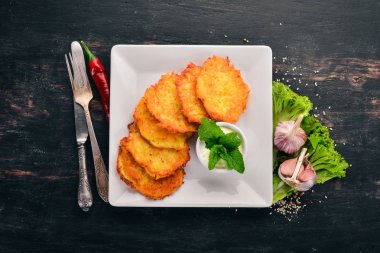 Patatesli Çörek ekşi krema ile. Patatesli krep. Ukraynalı mutfağı. Eski ahşap arka plan üzerinde. Metin için özgür yer. Üstten görünüm.