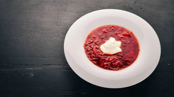 Vegetable beet soup. Borsch with sour cream. On the old wooden background. Free space for text. Top view. — Stock Image Vegetable Beet Soup Borsch Sour Cream Old Wooden Background Free Stock Photo