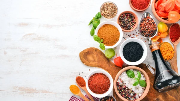 Een Aantal Specerijen Kruiden Een Witte Houten Tafel Basilicum Paprika — Stockfoto