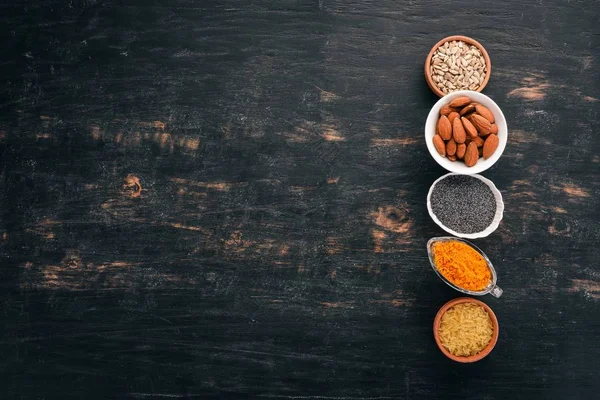 Bowls Various Superfoods Black Wooden Background Top View Free Copy — Stock Photo, Image