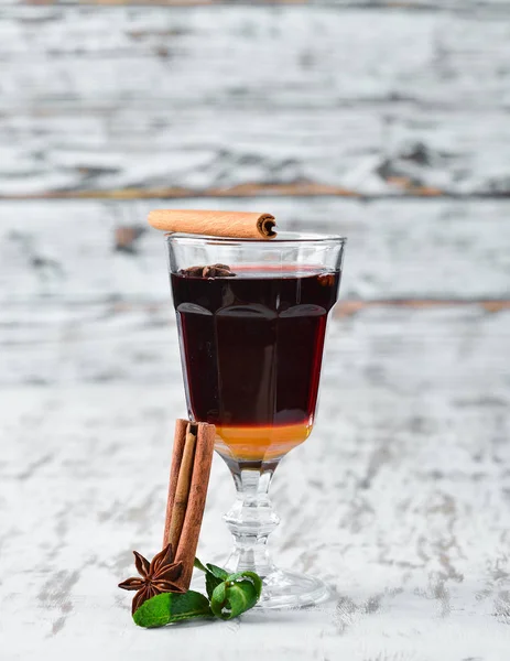 Hot winter wine cocktail. On a wooden background. Top view. Free copy space.