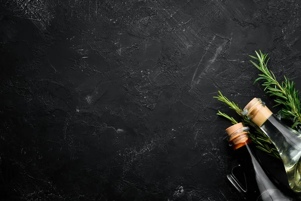 Oil and soy sauce on a black stone background. Top view. Free space for your text.