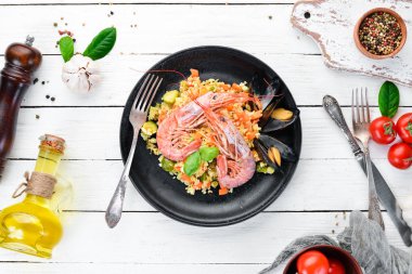 Bulgur karides, midye ve sebze. Eski arka plan üzerinde. Üstten Görünüm. Metniniz için boş alan.