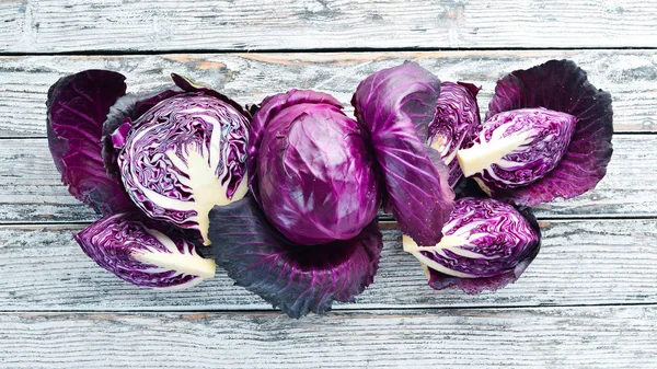 Red cabbage. Purple cabbage on a white wooden background. Organic food. Top view. Free space for your text.