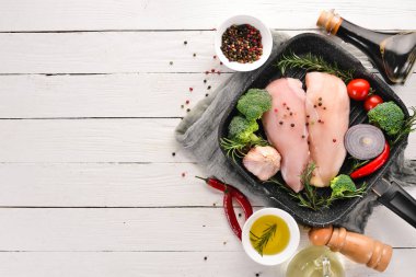 Baharat ve otlar ile çiğ tavuk göğsü. Barbekü. Siyah taş arka plan üzerinde. Üstten Görünüm. Ücretsiz kopya alanı.