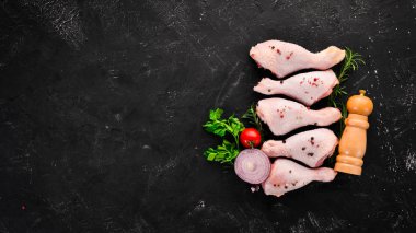 Çiğ tavuk budu ve baharat ve otlar. Barbekü. Beyaz ahşap zemin üzerinde. Üstten Görünüm. Ücretsiz kopya alanı.