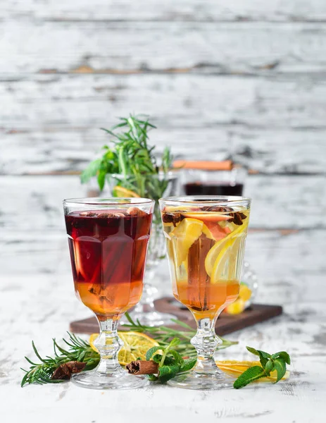 Hot winter wine cocktails. Cinnamon, cloves and honey. On a wooden background.