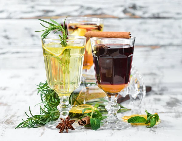 Hot winter wine cocktails. Cinnamon, cloves and honey. On a wooden background.