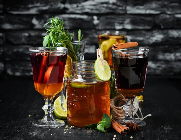 Hot winter wine cocktails. Cinnamon, cloves and honey. On a wooden background.