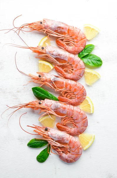 Large shrimp with lemon. Top view. Free space for your text. On the old background.