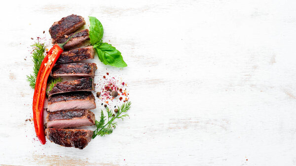 Veal steak. On a wooden background. Top view. Free space for your text.