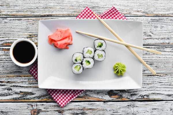 Vegetarian sushi roll with cucumber. Japanese cuisine. Top view.