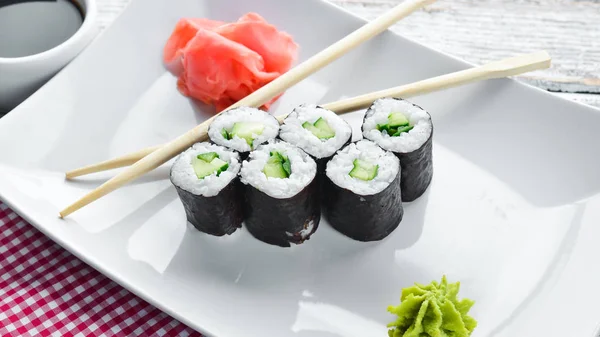 Vegetarian sushi roll with cucumber. Japanese cuisine. Top view.