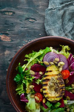 Salata. Marul, pancar, avokado ve Kabak tohumları. Üst görünüm. Siyah bir arka planda. Ücretsiz kopya alanı.