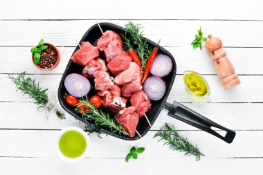 Çiğ şap kebabı. baharat ve otlar ile barbekü et. Beyaz ahşap bir arka planda. Üst görünüm. Ücretsiz kopya alanı.