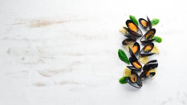 Bir tabak baharatlar ile haşlanmış midye. Üst görünüm. Metniniz için boş alan. Eski arka planda.