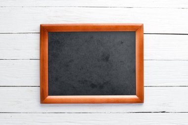 Wooden board for notes. On the old background. Top view. Free copy space.