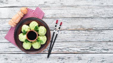 Hinkali et, ıspanak ve soya sosu ile. Siyah bir arka plan üzerinde. Üst te. Ücretsiz kopyalama alanı.