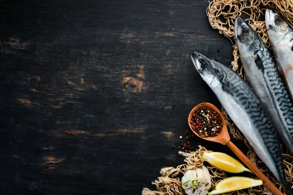 Fish. Raw Mackerel on a black wooden background. Top view. Free copy space. — Stock Image Fish Raw Mackerel Black Wooden Background Top View Free Copy Stock Photo