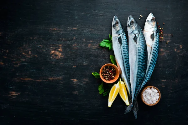 Fish. Raw Mackerel on a black wooden background. Top view. Free copy space. — Stock Image Fish Raw Mackerel Black Wooden Background Top View Free Copy Stock Picture