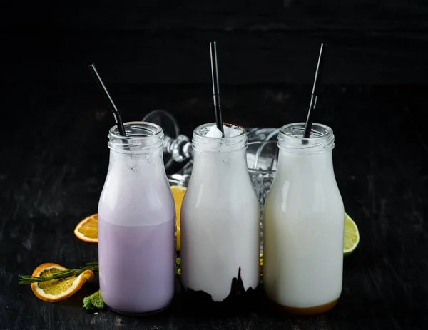 Milk-shake. Ice cream, milk and fruit. On a wooden background. Top view.