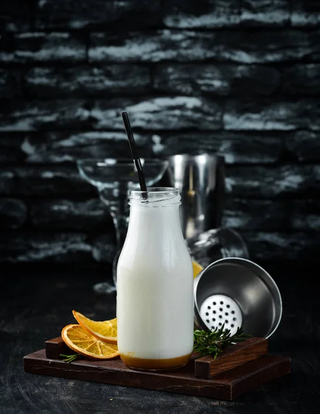 Milk-shake. Ice cream, milk and fruit. On a wooden background. Top view.